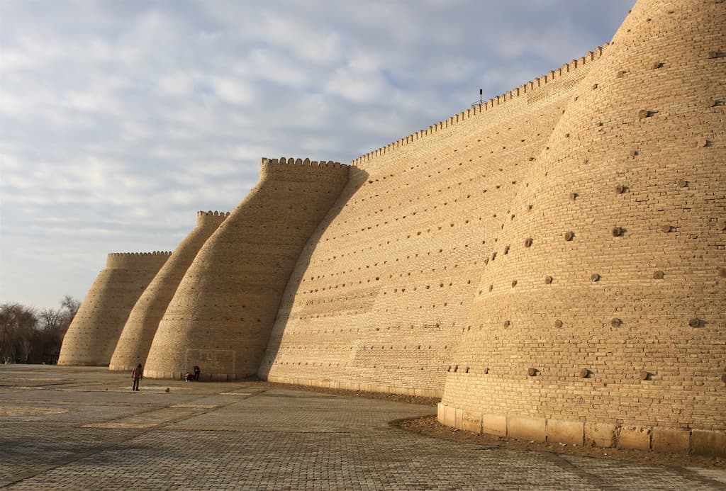 side angle of the magestic ark of bukhara and fort during sunset