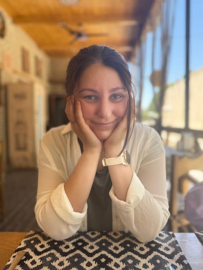 A tourist looking exhausted and red from the intense summer heat while exploring Uzbekistan.