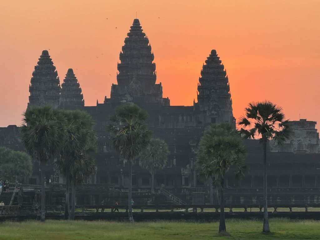 Stunning sunrise behind the main towers of Angkor Wat temple in Siem Reap, Cambodia, which we visited as part of the 2-day angkor wat tour we booked.