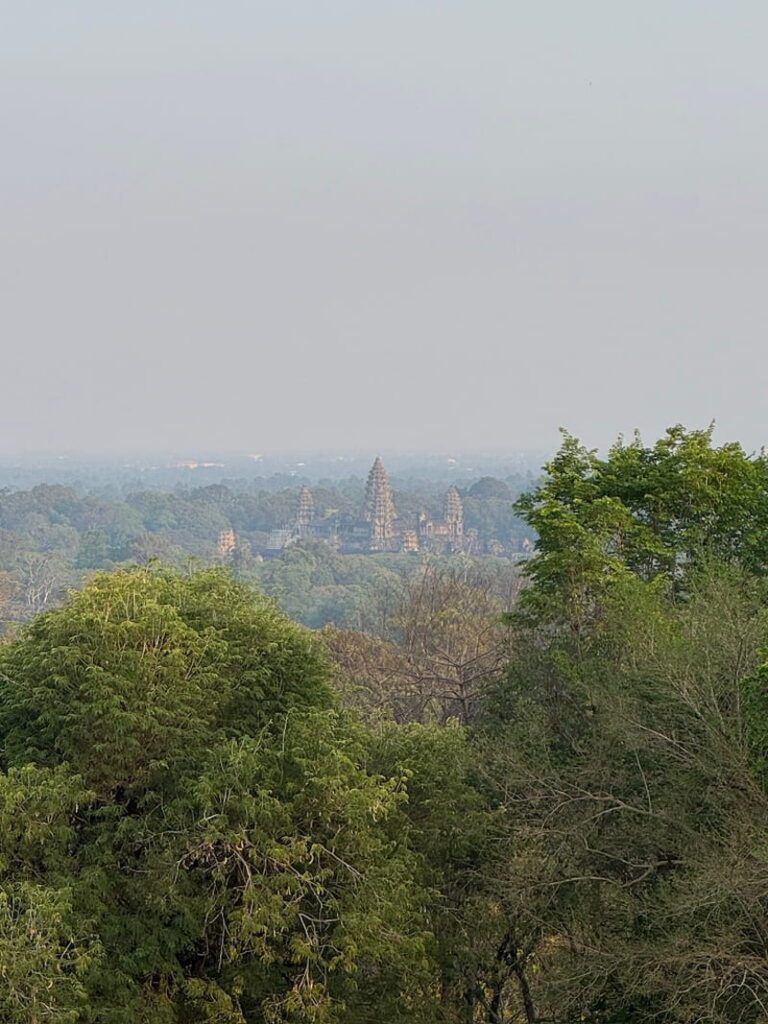 Distant view of Angkor Wat temple seen from the elevated viewpoint at Phnom Bakheng.