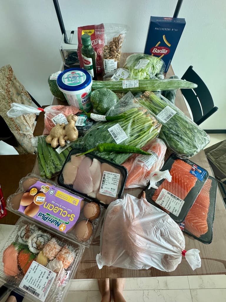 Healthy groceries on a table, a great way to save money for travel by cooking at home instead of dining out.