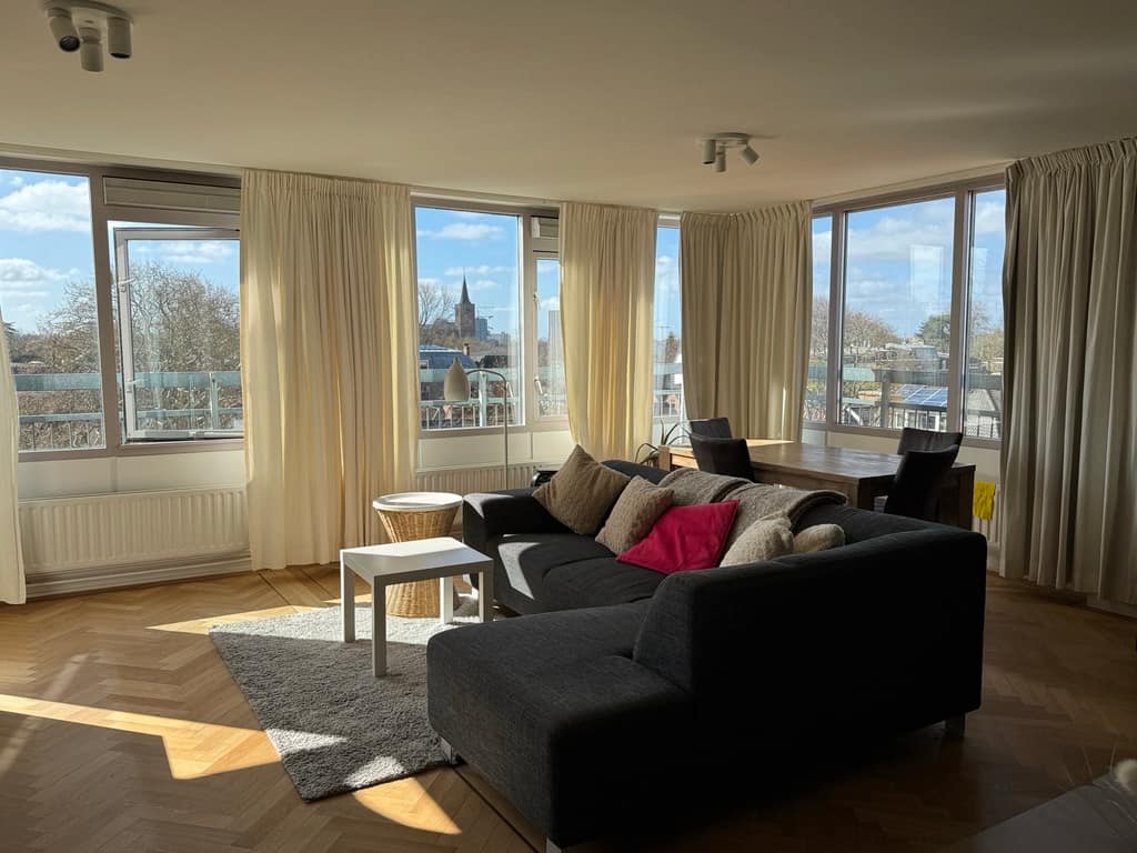 Bright, sunny living room in the former home of Eleni and Alessandro, the travel bloggers behind Beyond Our Footprints, in Leiden, Netherlands, which we left behind to begin our year-long international travel journey.