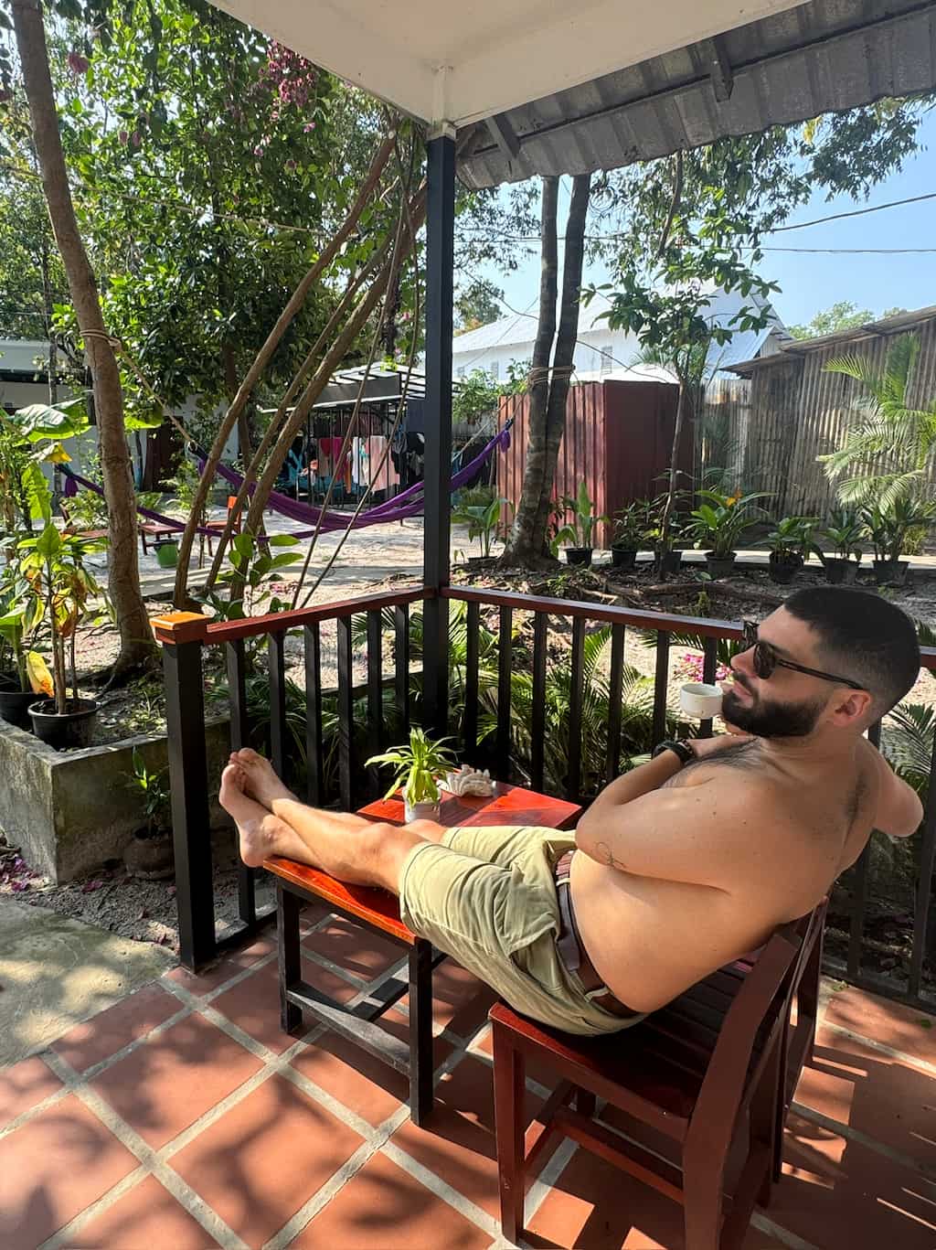 Ale relaxing with his feet up on the porch of a private room at Onederz, a popular saracen bay accommodation in Cambodia.