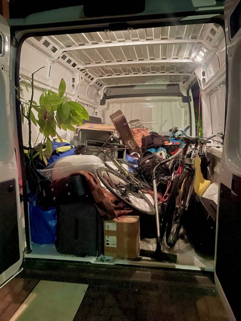 the interior of a van full of things we packed, including bicycles, plants, boxes, suitcases and more, to be driven back to Italy for storage