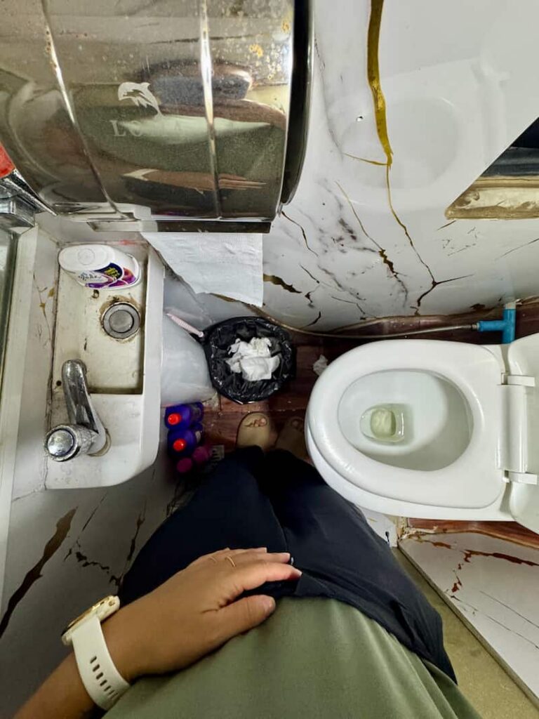 Overhead view of the compact private bathroom inside a VIP van, reviewed in our Cambodia transport guide
