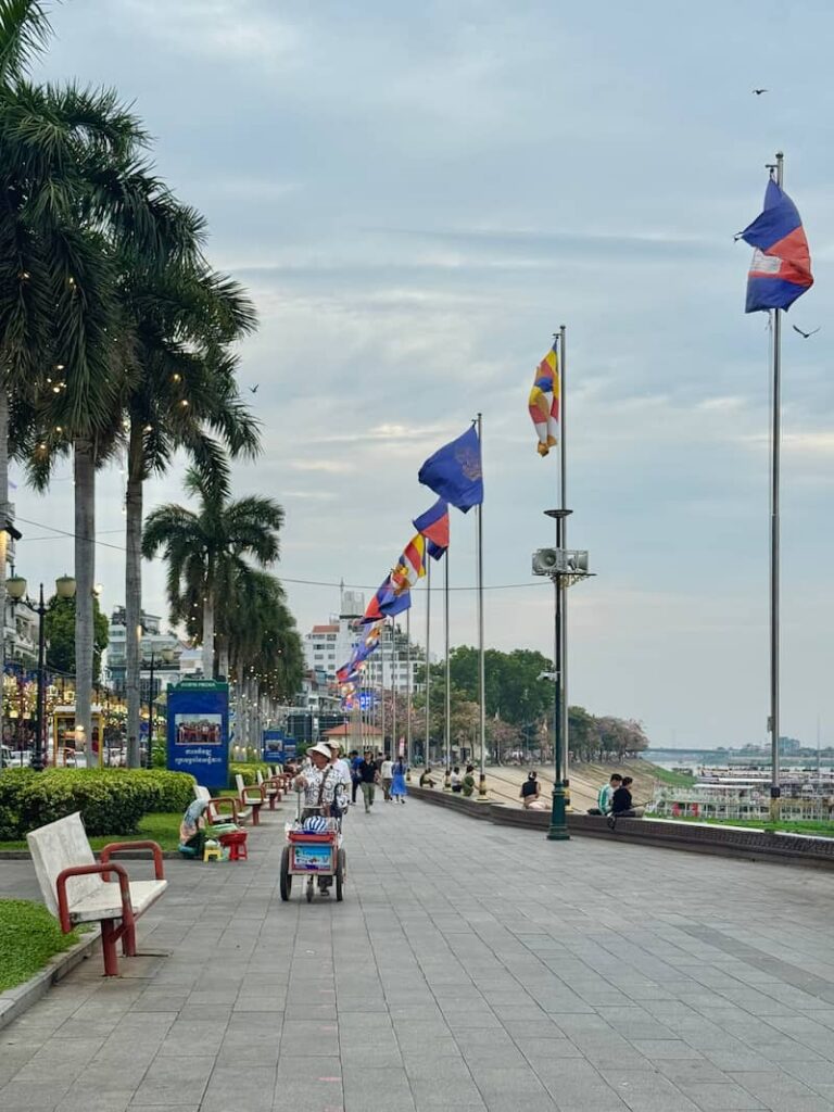 A scenic paved walkway along the Phnom Penh riverside, capturing the peaceful vibe that makes travelers wonder: Is Phnom Penh worth visiting?