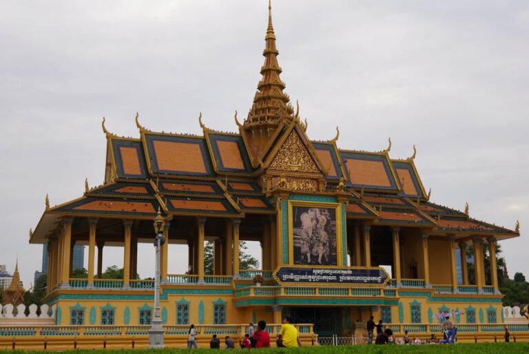 The ornate gold and yellow architecture of the Moonlight Pavilion at the Royal Palace in Phnom Penh, Cambodia.