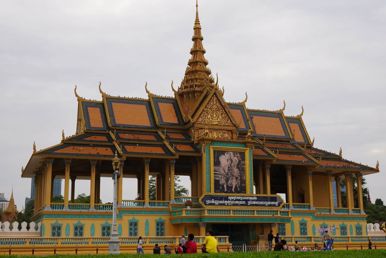 The ornate gold and yellow architecture of the Moonlight Pavilion at the Royal Palace in Phnom Penh, Cambodia.