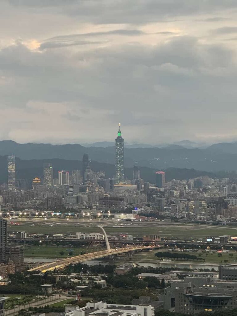 Panoramic view of the Taipei skyline featuring Taipei 101 and Songshan Airport from a hiking viewpoint