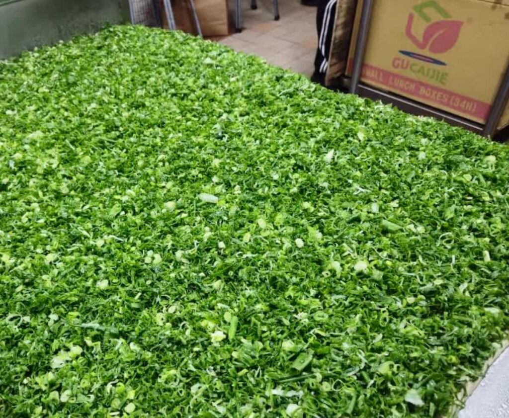 A large surface covered with a thick mound of finely chopped green onions.