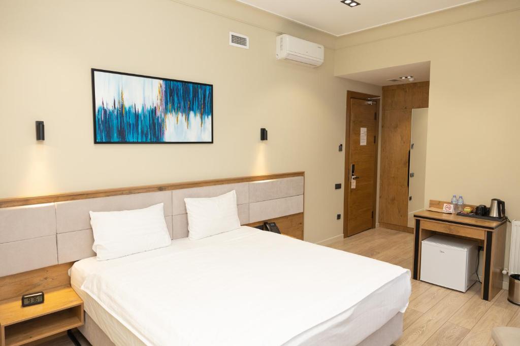 Clean and spacious double room interior with minimalist furnishings at a hotel in Tashkent, Uzbekistan.