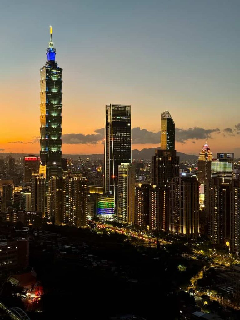 Illuminated Taipei 101 skyscraper and Taipei city skyline at twilight from Elephant Mountain viewpoint, as featured in our guide anwering the question 'is elephant mountain worth it?'